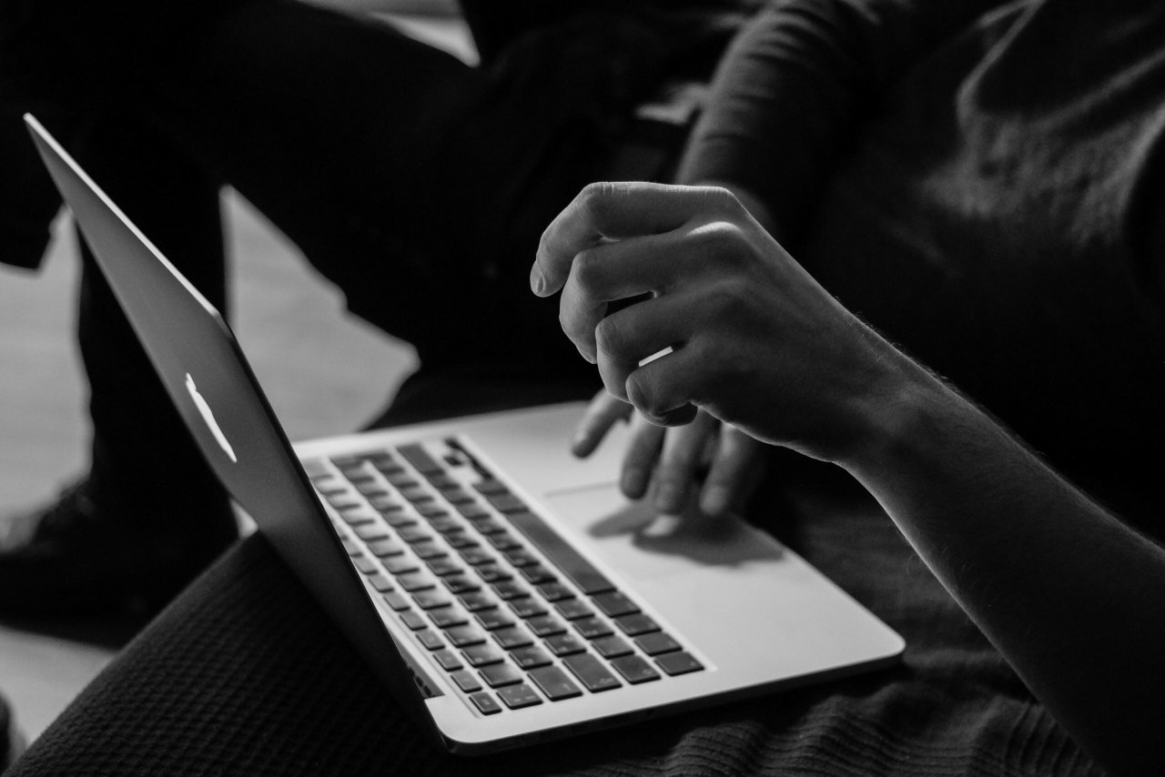 Black and white image of a woman with her laptop - Destination Certification