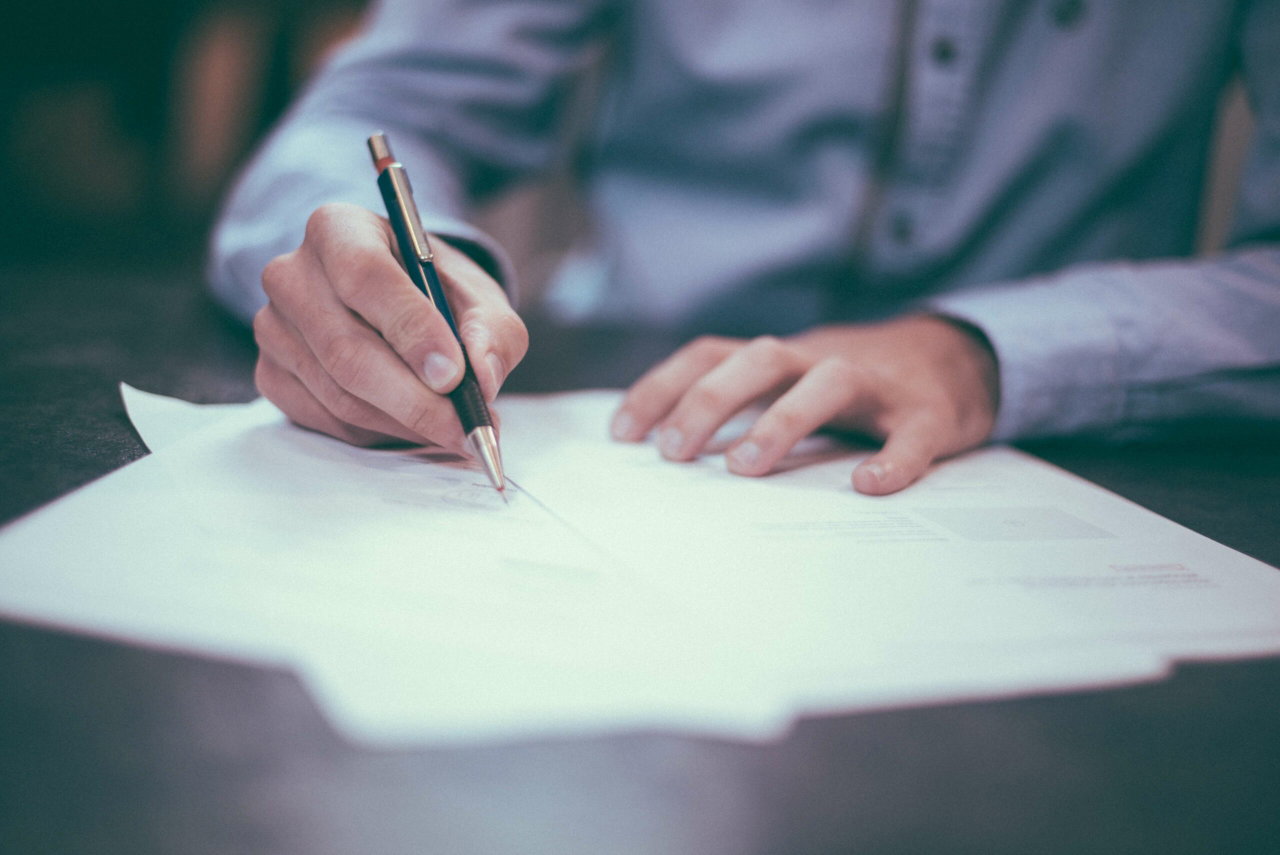 Image of a man signing a document - Destination Certification