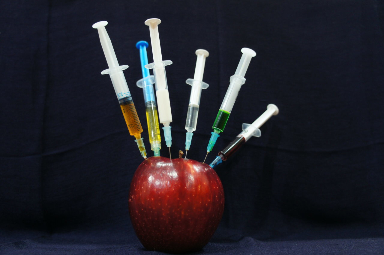 Image of an apple with needles